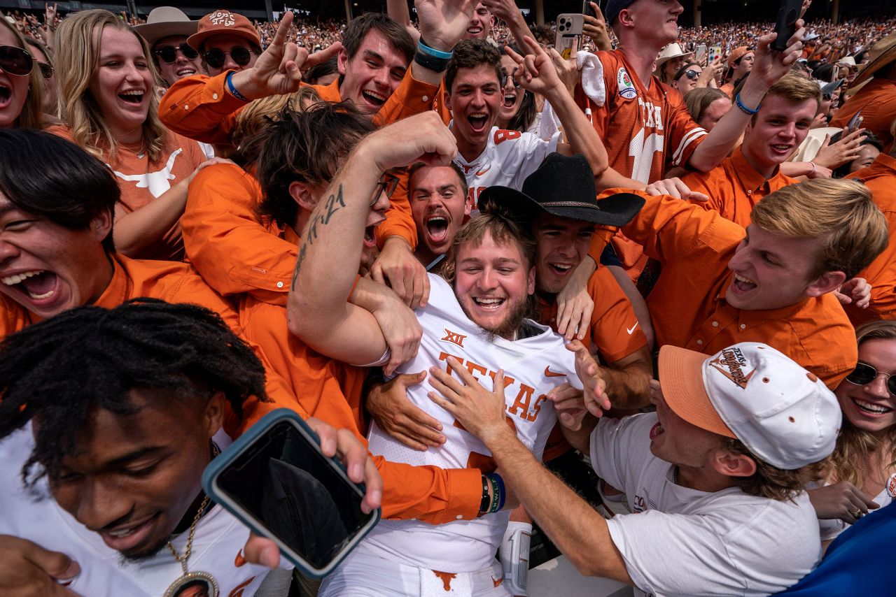 Texas quarterback Quinn Ewers celebrates with fans after the Longhorns crushed their rival Oklahoma 49-0 on Saturday, October 8. It was Oklahoma's worst loss in the history of the college football rivalry, which began in 1900.