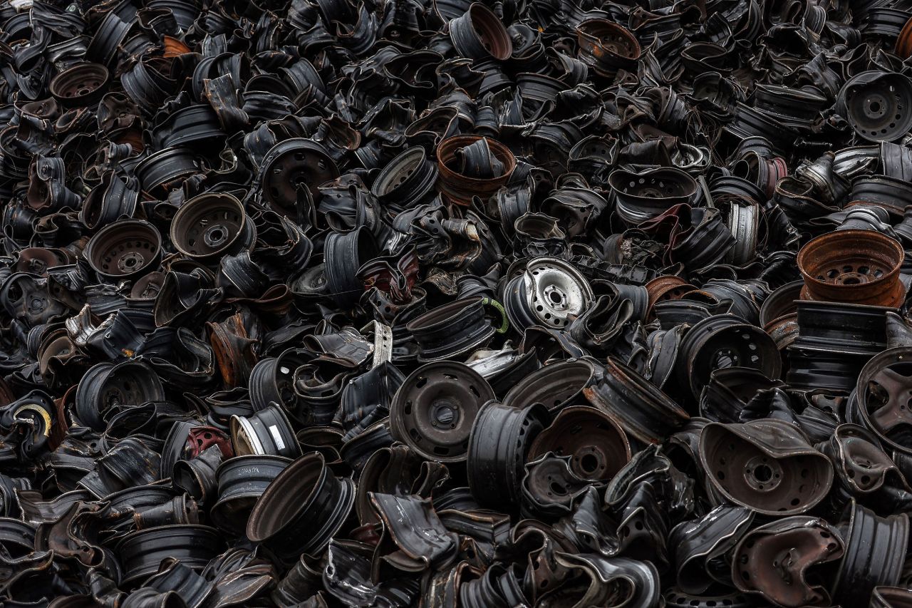 Wheels of damaged cars are seen at a dump in Gaillac, France, on Thursday, October 6.