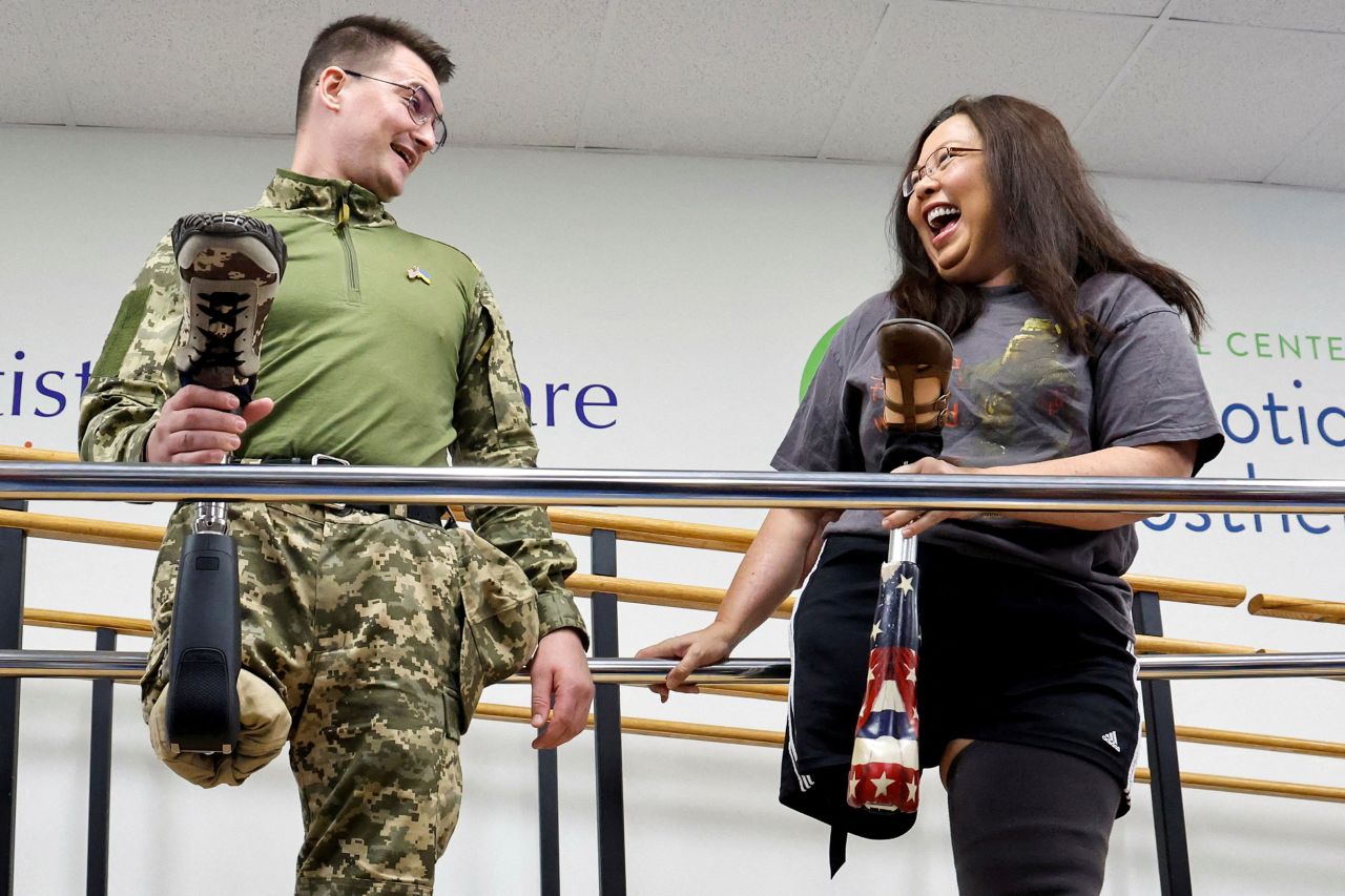 Ukrainian soldier Oleksandr Chaika shares a lighthearted chat with US Sen. Tammy Duckworth after receiving a prosthetic leg at a clinic in Silver Spring, Maryland, on Tuesday, October 11. Chaika lost his leg while serving in the Luhansk region of Ukraine. Duckworth lost her legs in 2004 while serving in the Iraq War.