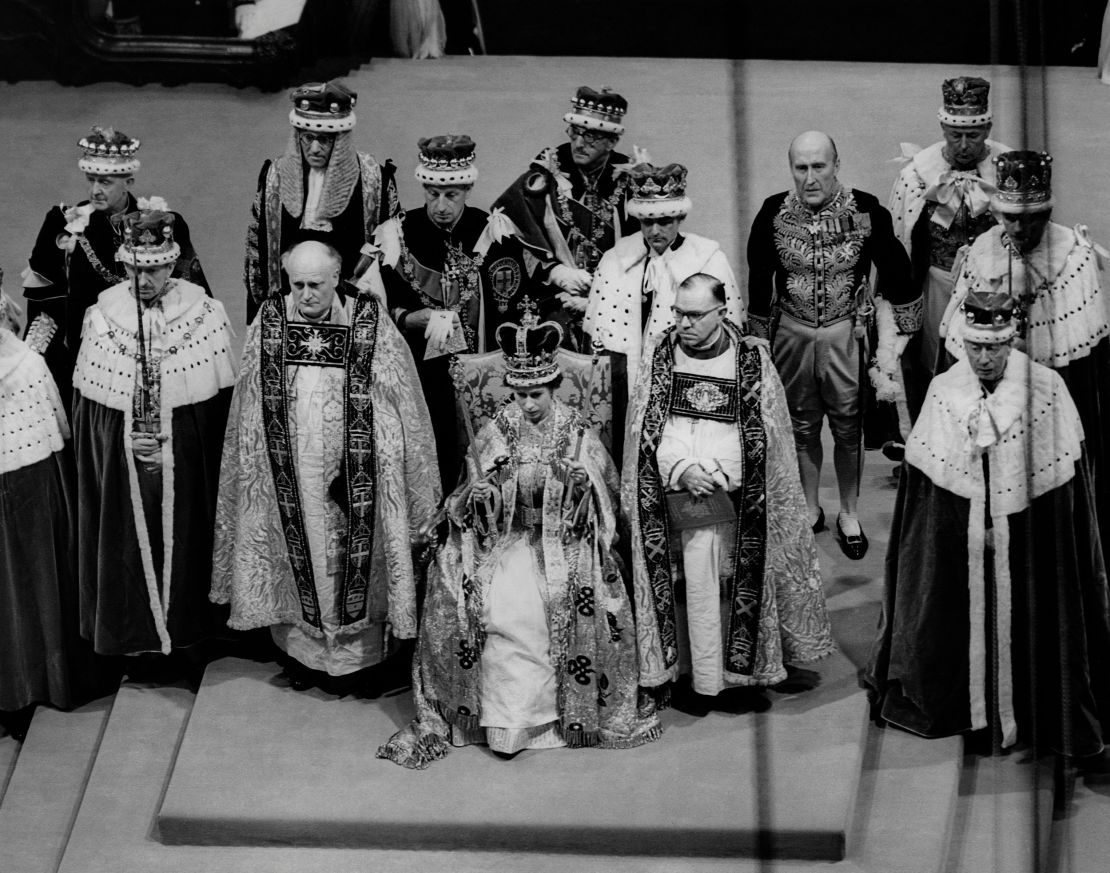 Queen Elizabeth II sits on a throne during her coronation in Westminster Abbey in London. 