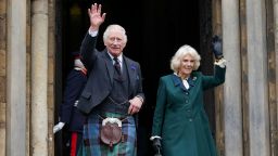 King Charles III and Camilla, Queen Consort, waves as they leave Dunfermline Abbey in Scotland.