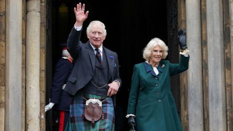 King Charles III and Camilla, Queen Consort, wave as they leave Dunfermline Abbey in Scotland.