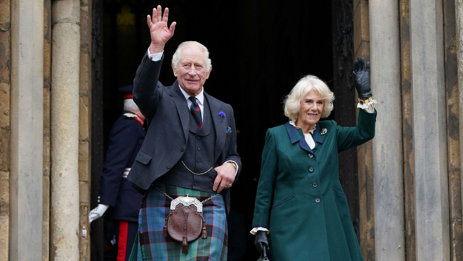 King Charles III and Camilla, Queen Consort, wave as they leave Dunfermline Abbey in Scotland.