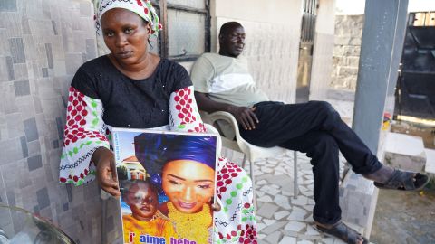 Mariama Kuyateh, 30, holds a photograph of her son, Musawho, who died from acute kidney failure, in Banjul on October 10, 2022. 