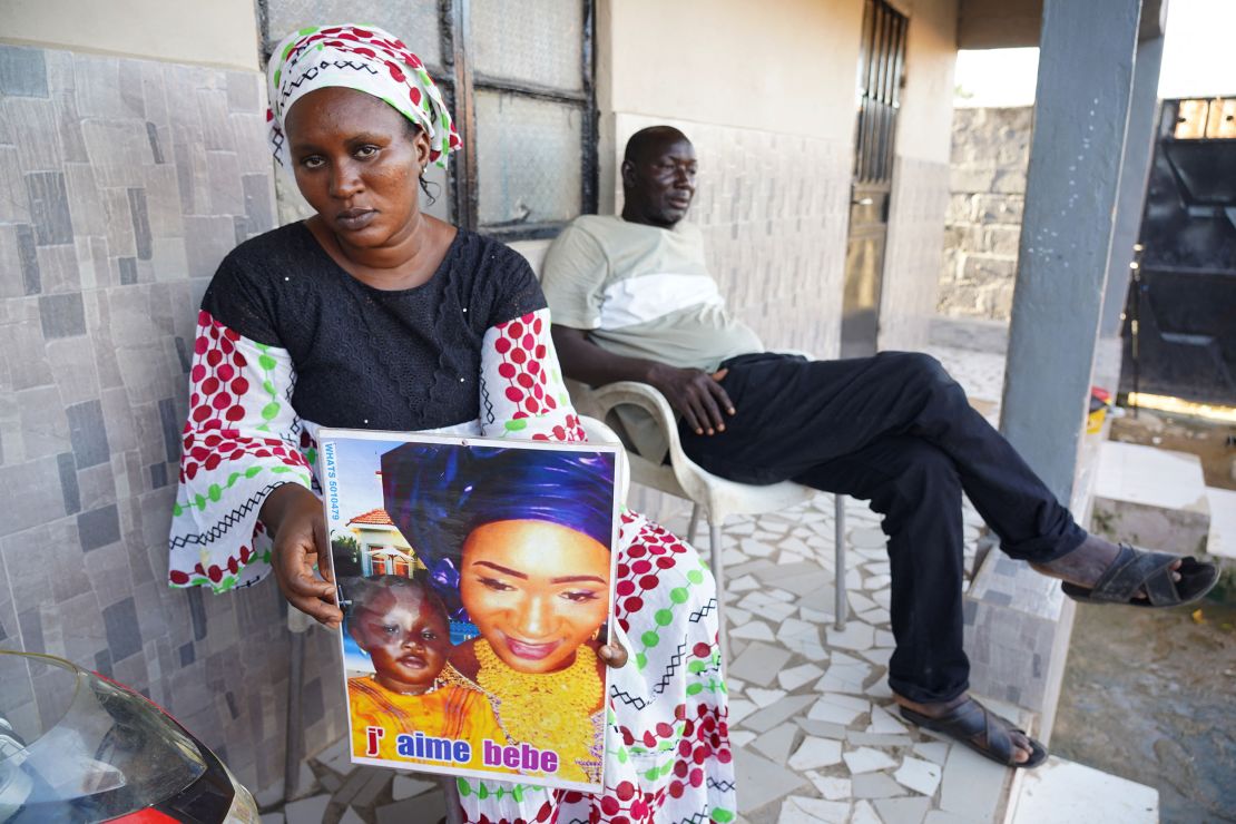 Mariama Kuyateh, 30, holds a photograph of her son, Musawho, who died from acute kidney failure, in Banjul on October 10, 2022. 