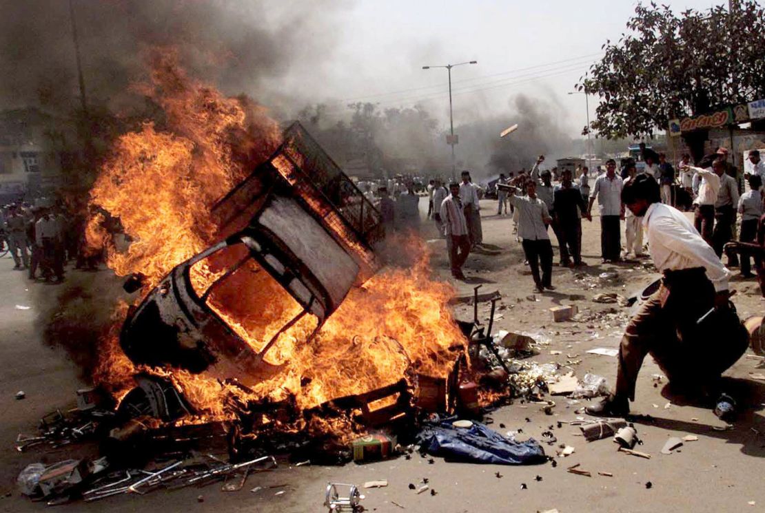 Protesters burn vehicles during riots in Ahmedabad, India, February 28, 2002.