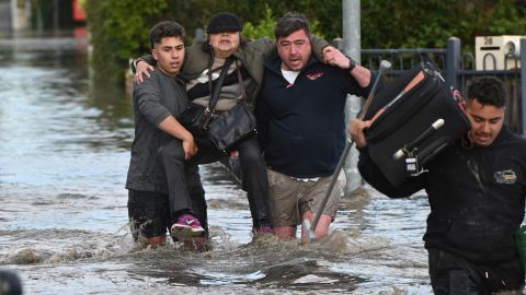A woman is rescued from floodwaters amidst evacuation orders in the Maribyrnong suburb of Melbourne, Australia, on October 14, 2022. 