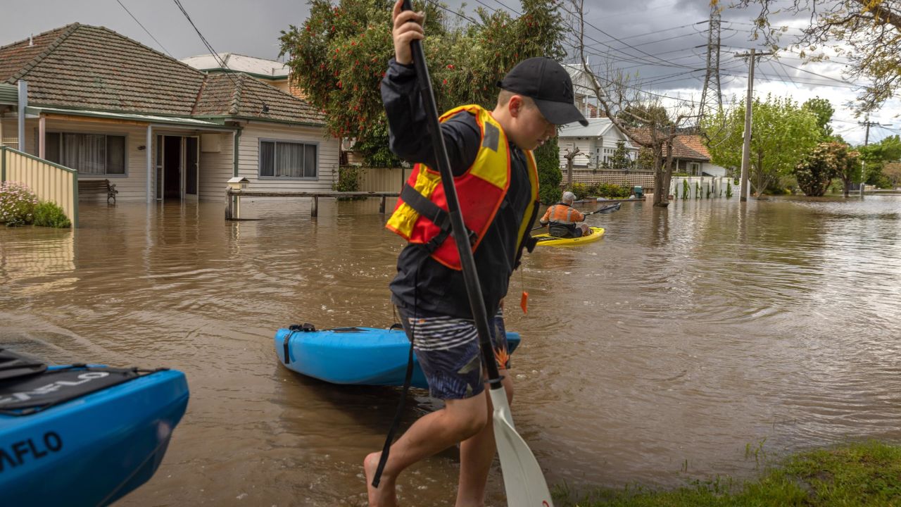 A resident in the suburb of Maribyrnong canoeing down a flooded street. 