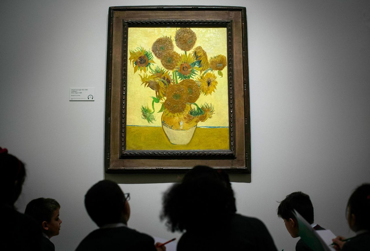 School children look at 'Sunflowers' (1888) by Vincent van Gogh at Tate Britain in London on March 25, 2019.