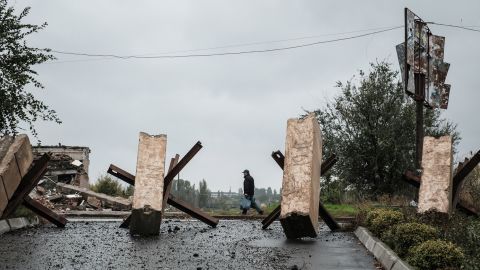 A man walks near anti-tank obstacles in the frontline town of Bakhmut in the Donetsk region on Tuesday.