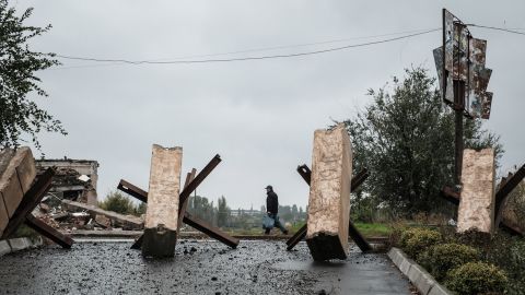 A man walks near anti-tank obstacles  in the frontline town of Bakhmut in the Donetsk region on Tuesday.