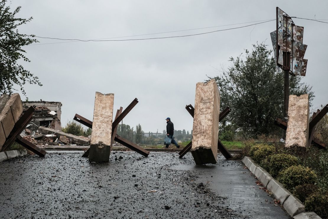 A man walks near anti-tank obstacles  in the frontline town of Bakhmut in the Donetsk region on Tuesday.