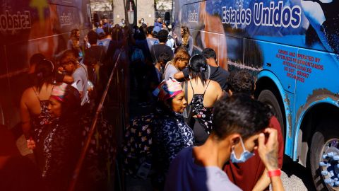 Migrants, mostly from Venezuela, line up on September 16 to board a bus to New York at a welcome center managed by the city of El Paso, Texas.