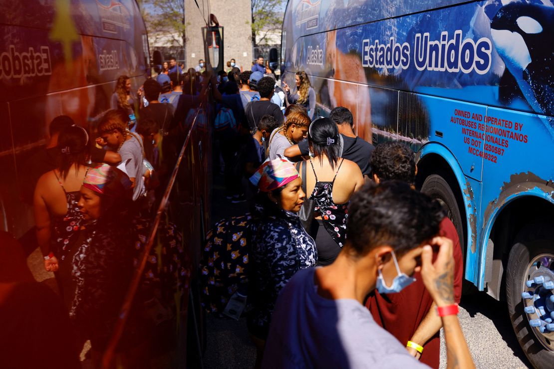 Migrants, mostly from Venezuela, line up on September 16 to board a bus to New York at a welcome center managed by the city of El Paso, Texas.