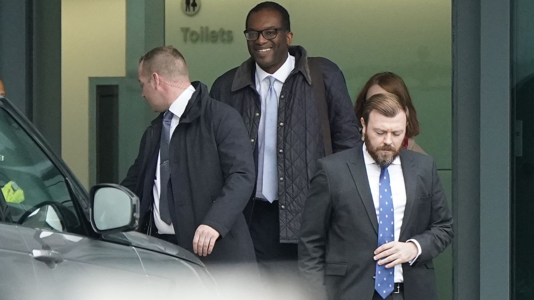Kwasi Kwarteng (second left) arrives at London Heathrow Airport on Friday after being summoned back from the US.