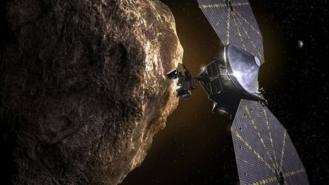 This illustration shows the Lucy spacecraft passing one of the Trojan Asteroids near Jupiter.