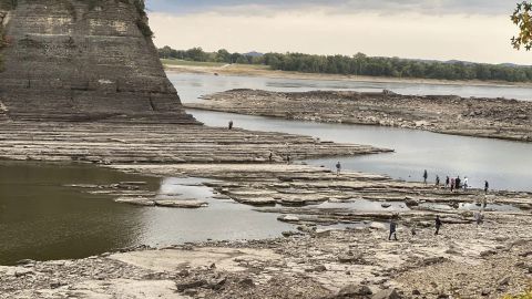 People walk across the Mississippi River to reach Tower Rock. 