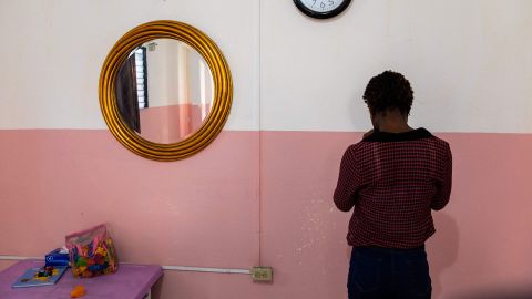 An anonymous victim of sexual abuse poses for a photo at the Doctors Without Borders' 