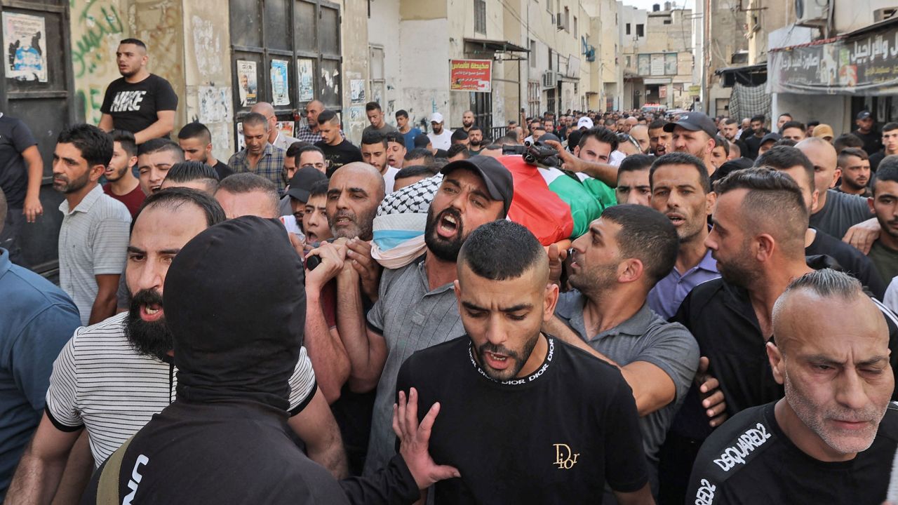 Mourners carry the body of Abdullah al-Ahmad on October 14.