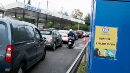 Motorists queue for fuel at a Leclerc SA gas station, with fuel shortages, on the outskirts of Paris, France, on Friday, Oct. 14, 2022. Refinery worker walkouts, which have affected most of the France's refineries, have left almost a third of the country's gas stations with supply shortfalls, according to government data.