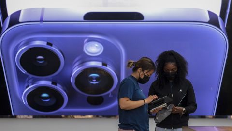 An employee assists a customer at the Apple The Grove in Los Angeles on Friday, Sept. 16, 2022.