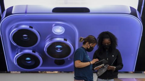 An employee assists a customer at the Apple The Grove in Los Angeles on Friday, Sept. 16, 2022. 