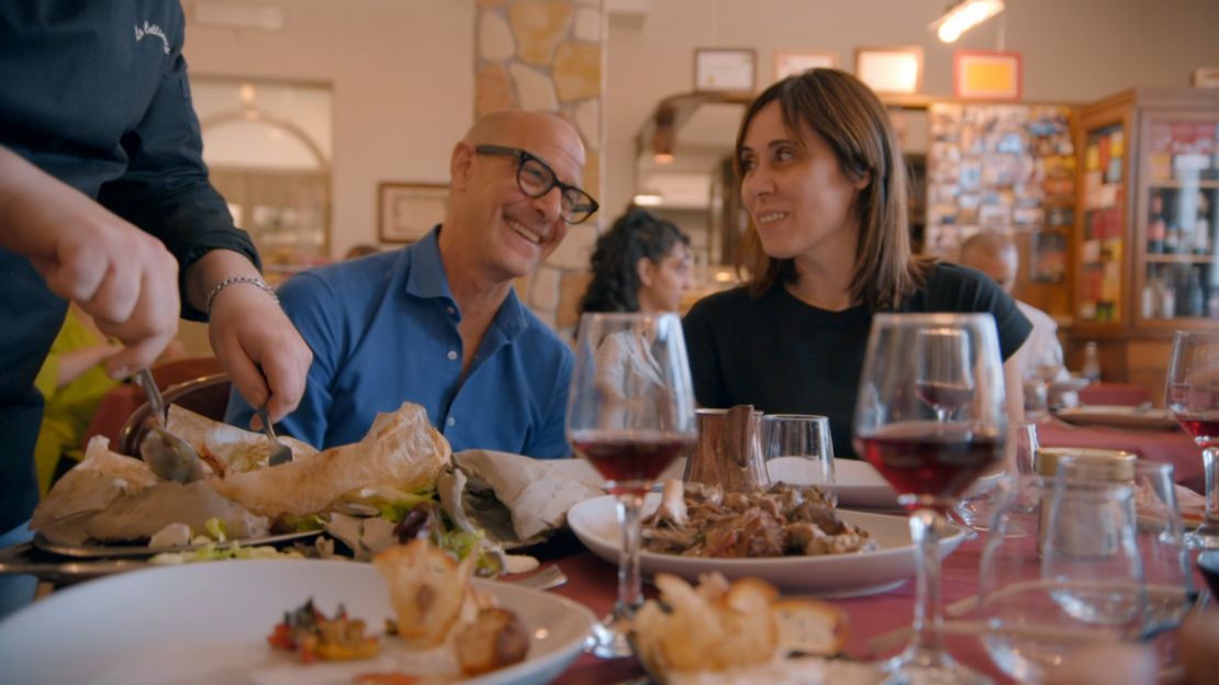 At La Collinetta, (from left) Stanley Tucci and farmer and activist Annalisa Fiorenza sample the ancient dish of lamb cooked in clay.