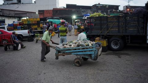 A man pushes a cart with pumpkins outside a public market in San Cristobal, Venezuela, April 7, 2022.