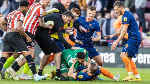 Blackpool's Shayne Lavery is taken to ground by Sheffield United's goalkeeper Wes Foderingham.