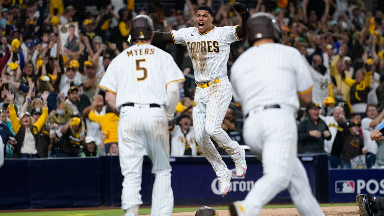 San Diego Padres' Juan Soto, center, reacts after scoring off a two RBI single by Jake Cronenworth during the seventh inning in Game 4
