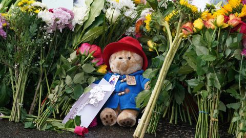 Floral tributes and a Paddington teddy bear are laid at the gates of Balmoral in Scotland, following the death of Queen Elizabeth II on Thursday. Picture date: Friday September 9, 2022. 