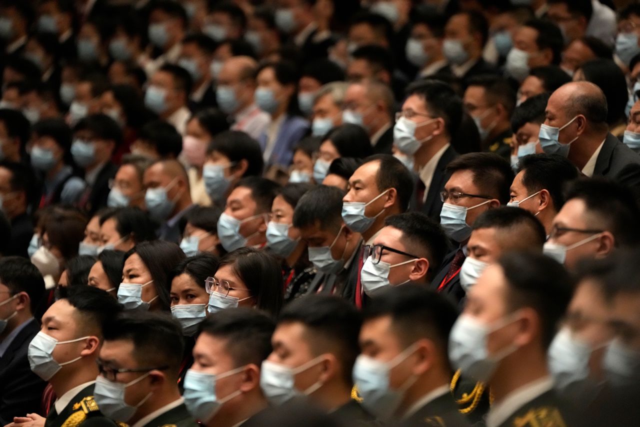 Delegates wearing masks attend the opening ceremony.