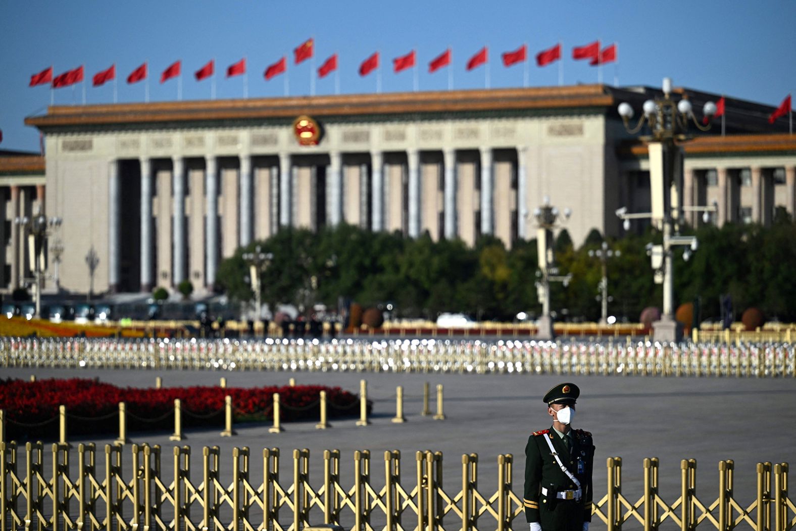 A security guard stands outside the Great Hall of the People.