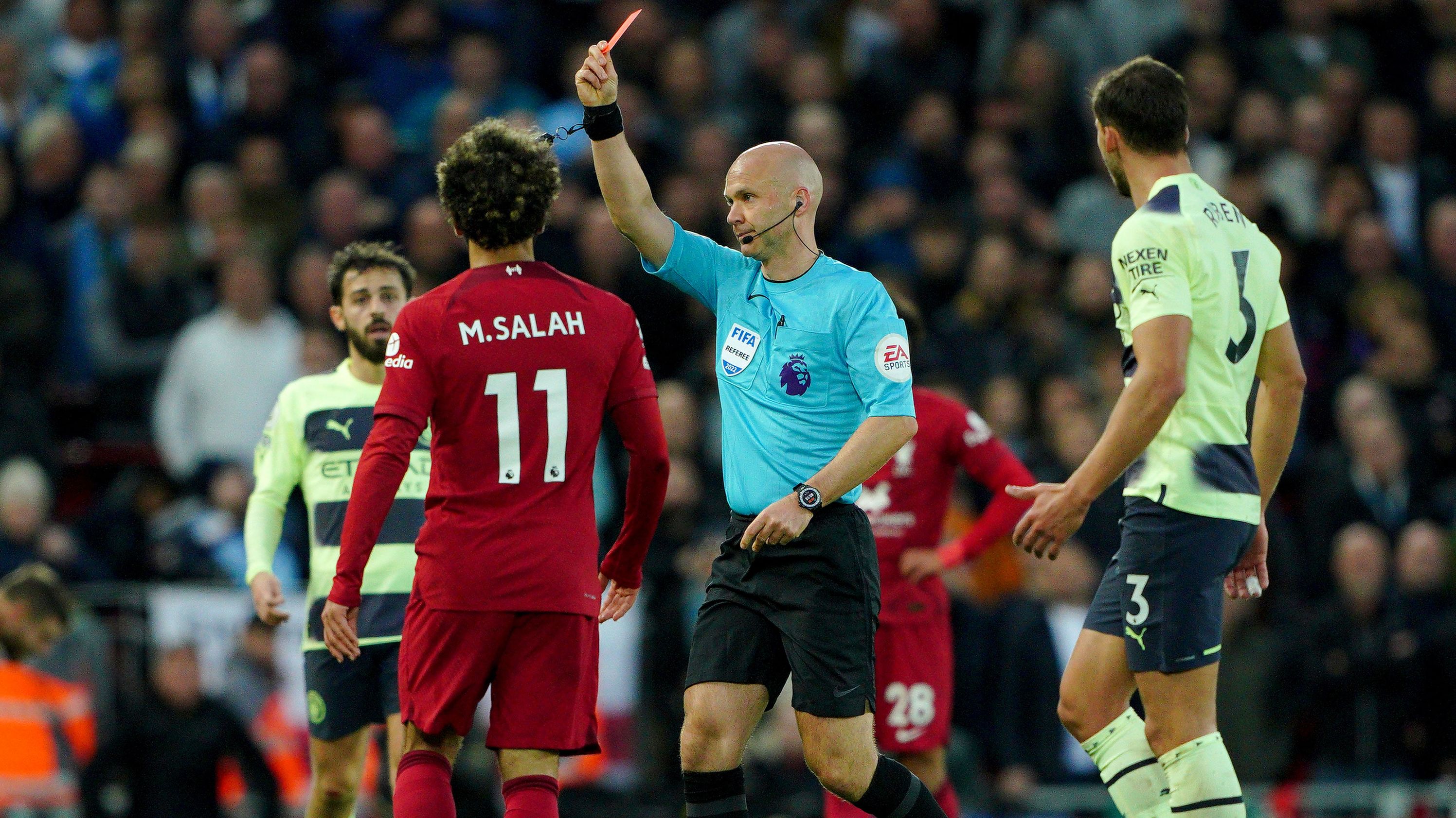 Referee Anthony Taylor shows a red card to the Liverpool manager. 