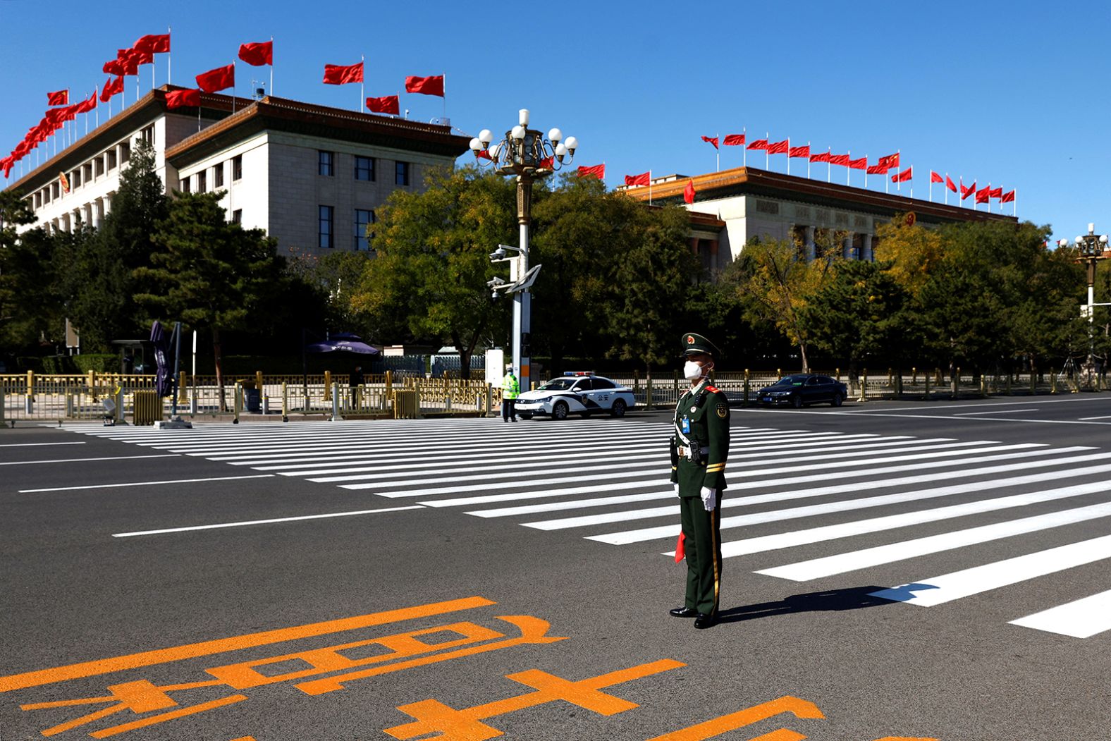 A paramilitary police officer stands guard outside the Great Hall of the People.