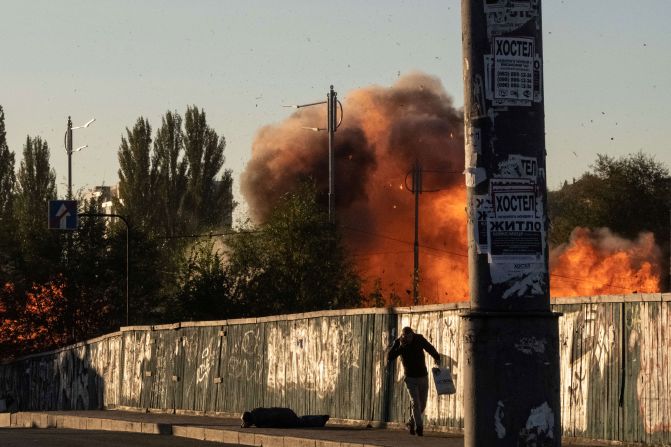 People react as a drone lands and explodes nearby in Kyiv on Monday.