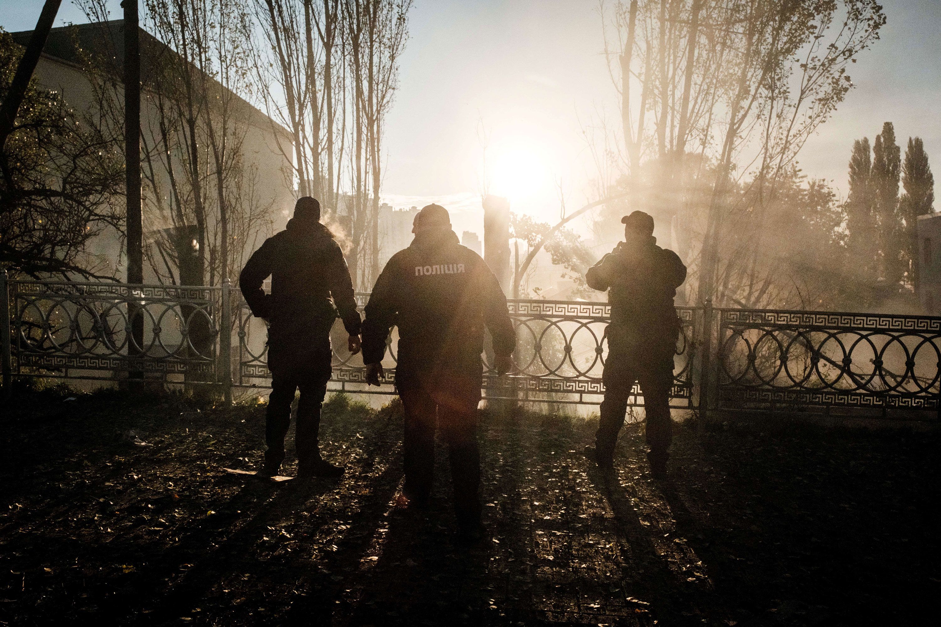 Police officers check the site of an explosion.