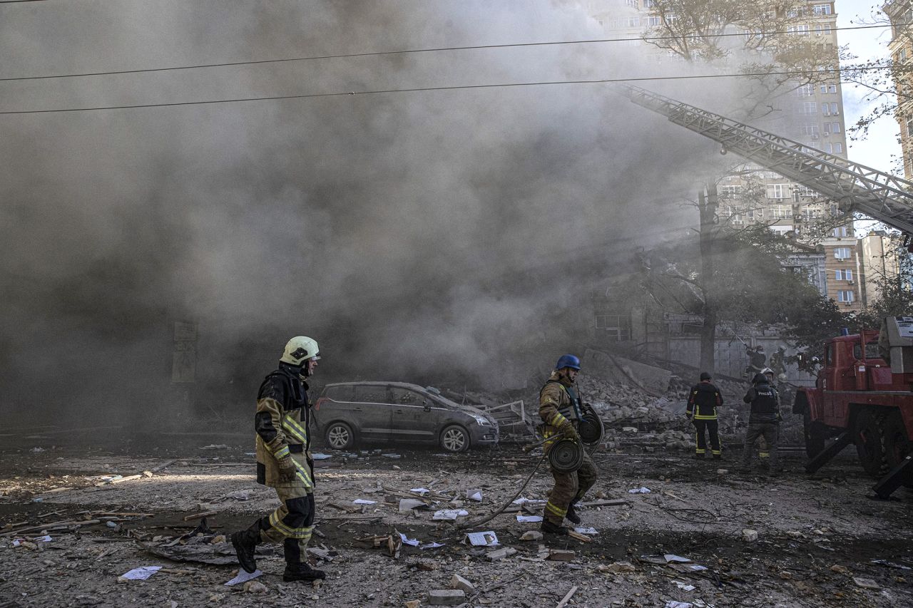 Firefighters work at a destroyed building after Russian drone attacks in Kyiv.