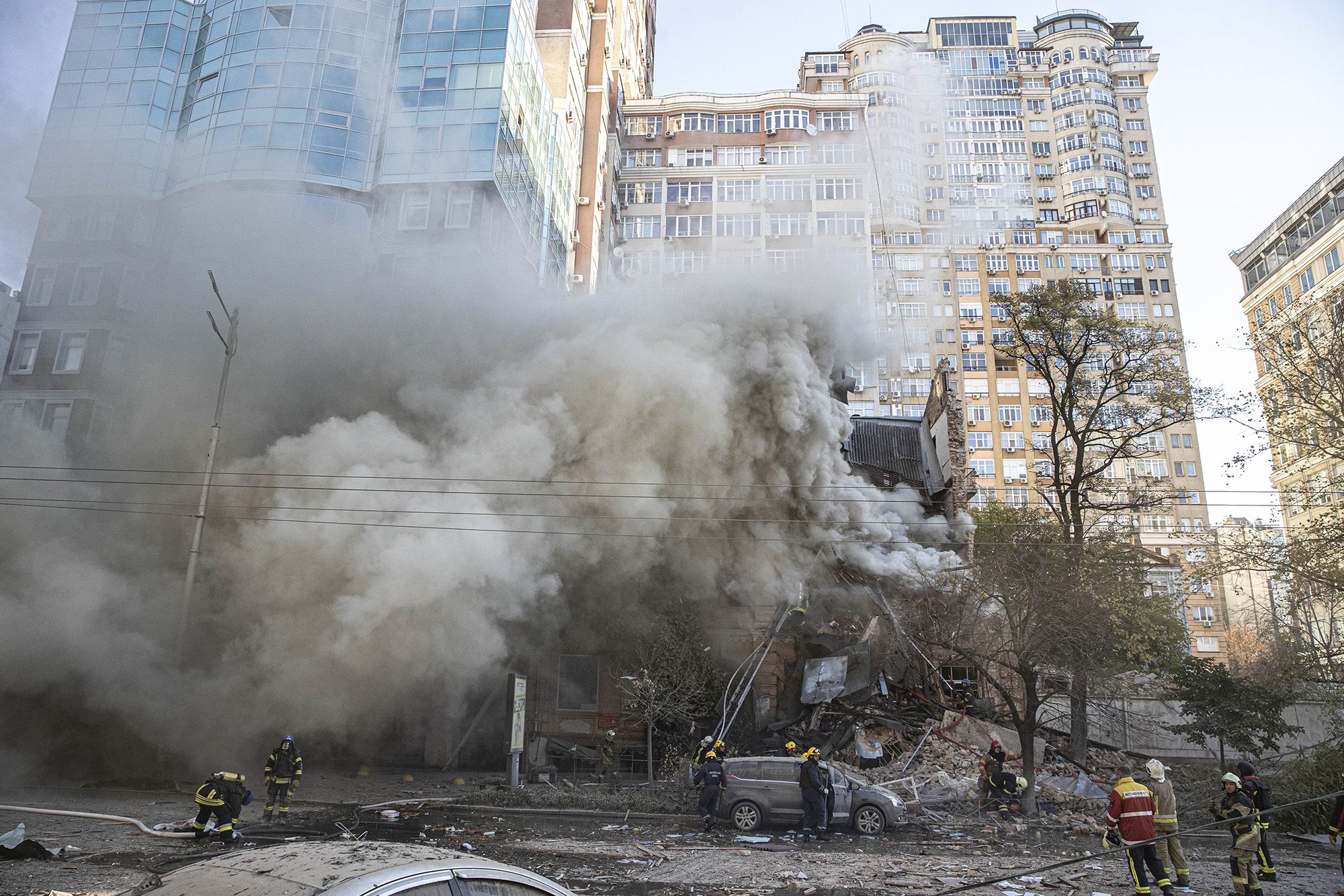 Firefighters work at a destroyed building after Russian drone attacks in Kyiv on Monday.