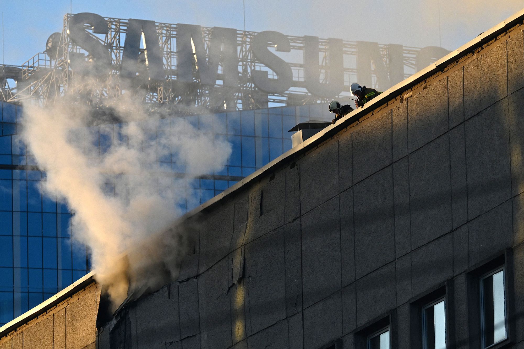 Ukrainian rescuers work on a roof after a drone attack in Kyiv on Monday.