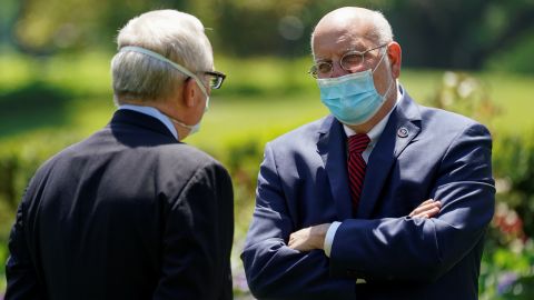 Then-assistant Secretary for Public Affairs at the US Department of Health and Human Services Michael Caputo speaks in May 2020 with then-Centers for Disease Control Director Robert Redfield at the White House in Washington, D.C.