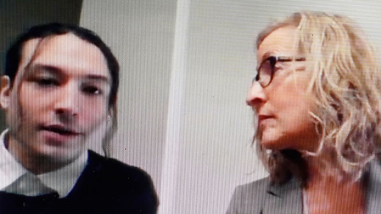 Actor Ezra Miller, left, is seated with attorney Lisa Shelkrot, right, as they appear Monday, Oct. 17, 2022, in a livestream video remotely from Burlington, Vt., during Miller's arraignment at superior court, in Bennington, Vt. Miller has pleaded not guilty to stealing bottles of liquor from a neighbor's home in Vermont. (AP Photo/Steven Senne)