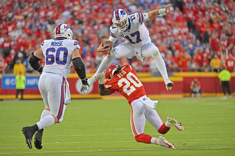 Buffalo Bills quarterback Josh Allen hurdles Kansas City Chiefs safety Justin Reid as he scrambles for a first down. Allen's fourth quarter touchdown throw to Dawson Knox capped off a 24-20 victory against the Chiefs. 