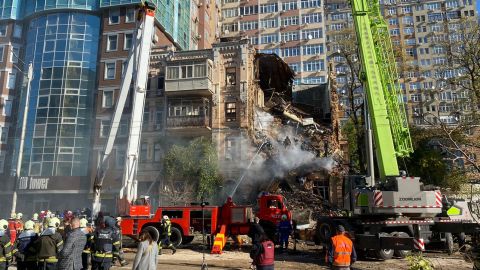 First responders work to rescue people from a drone strike in central Kyiv Monday.