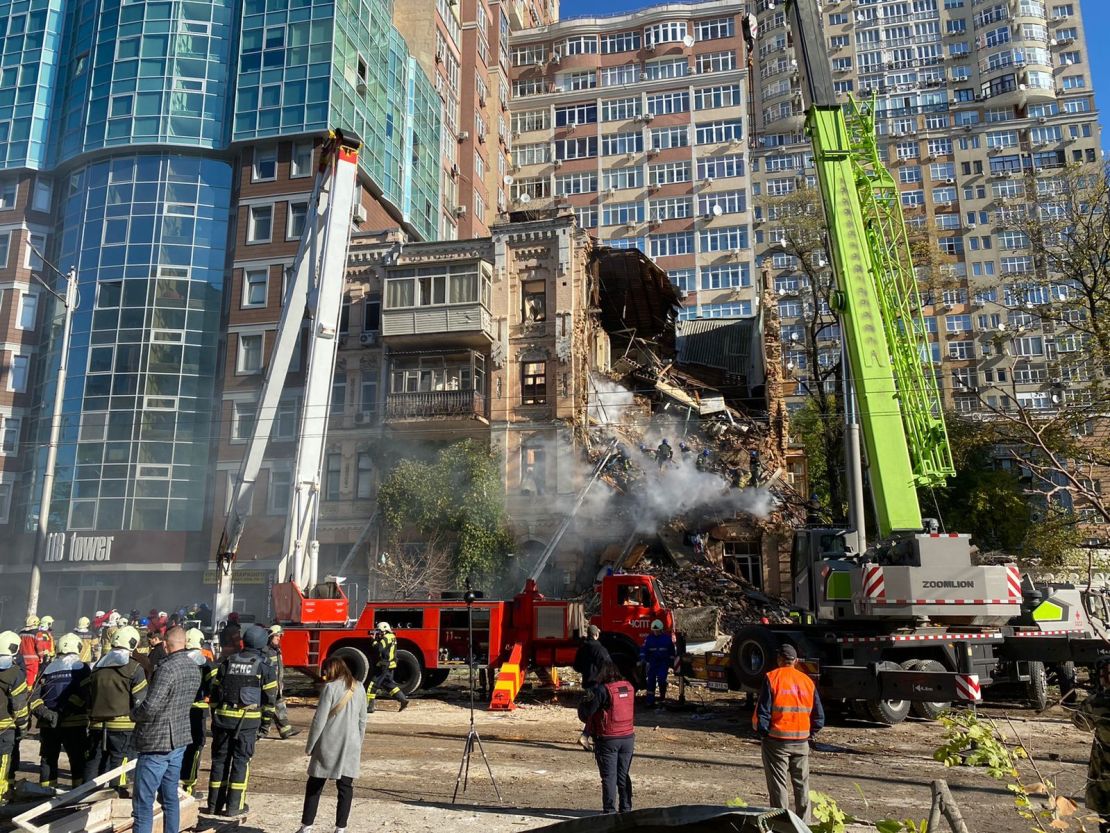 First responders work to rescue people from a drone strike in central Kyiv Monday.