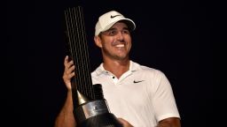 US golfer Brooks Koepka poses with his trophy following his play-off win in the LIV Golf Invitational-Jeddah at the Royal Greens Golf Club on October 16, 2022. - Four-time major-winner Brooks Koepka secured the biggest payday of his career with a $4 million play-off win over close friend Peter Uihlein on the Saudi-funded LIV Golf breakaway tour. (Photo by Amer HILABI / AFP) (Photo by AMER HILABI/AFP via Getty Images)