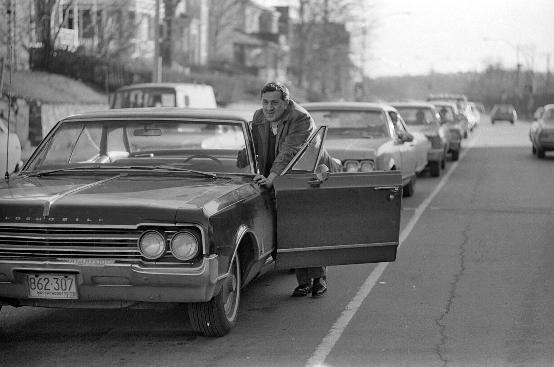 Drivers push cars to gas station during 'oil crisis,' Roslindale, Boston, Massachusetts, 1973. 