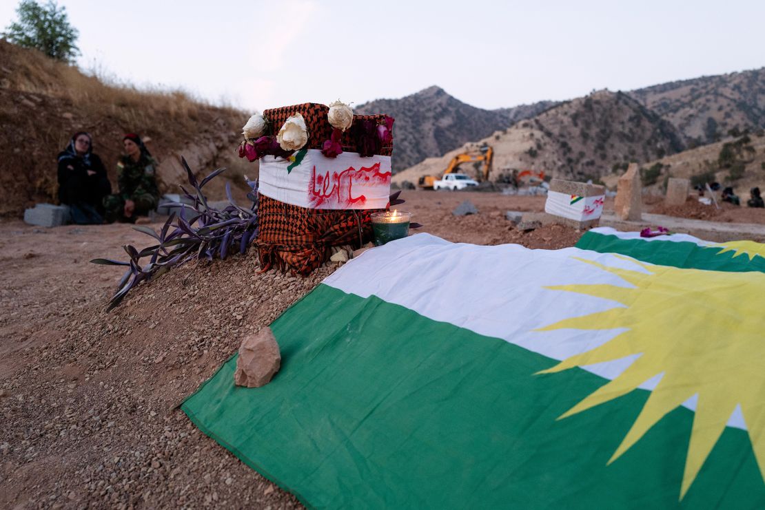 Freshly dug graves draped in the Kurdish nationalist flag where six of the eight militants who were killed in the September 28 Iranian attack were laid to rest. Two of the bodies have not yet been recovered.