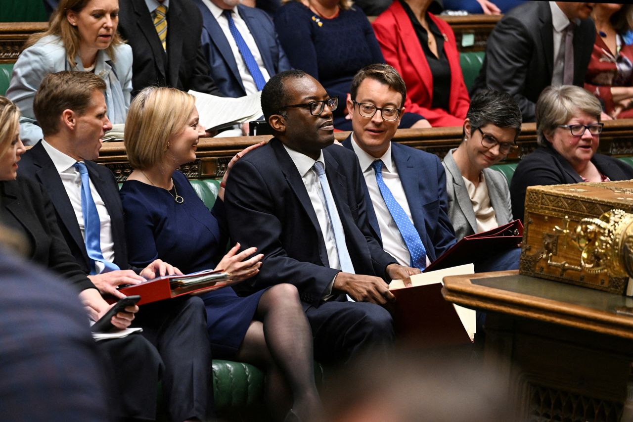 Truss and Chancellor of the Exchequer Kwasi Kwarteng, center, deliver the Government's Growth Plan statement at the House of Commons in September 2022. Kwarteng announced a controversial mini-budget full of unfunded tax-cutting measures <a href="https://www.cnn.com/2022/10/13/uk/liz-truss-ousting-analysis-intl-gbr/index.html" target="_blank">that sent financial markets into meltdown.</a> At one point, the pound sank to its lowest level against the dollar in decades. He was relieved of his duties weeks later.