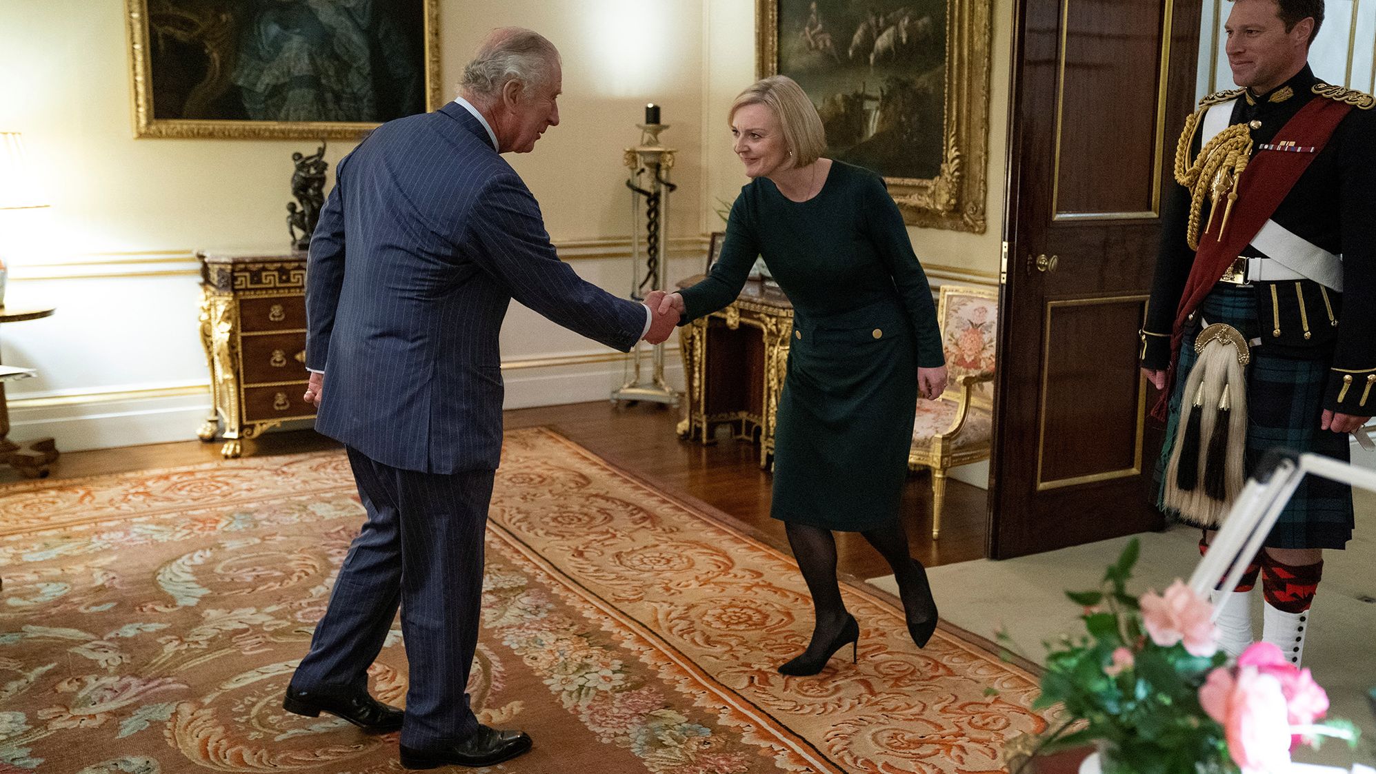 Britain's King Charles III shakes hands with Truss during a weekly audience at Buckingham Palace in October 2022.